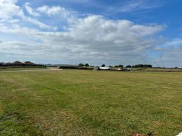 View across camping fields towards shower block and washing up area.
