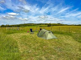 Grass tent pitch with views of the North Downs