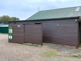 Onsite toilets and campsite notice board on lonely farm