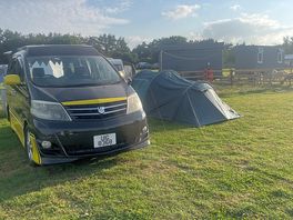 Small camper van with 3-man tent pitched alongside