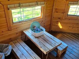 Cute table and benches in the cabin. bins provided.