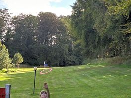 Space to play game surrounded by woods.