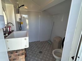 Shower room with toilet and washing up sink