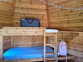 Cute bunk bed for children with coat hangers.