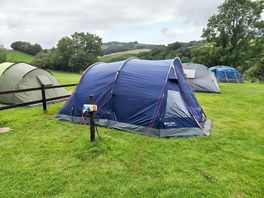 Our wee tent, handy for the electric hook-up and drinking water tap.