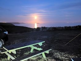 Orange moon over the ocean was beyond beautiful to watch