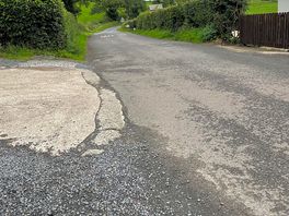 60mph road to the left. no pathways to walk along.
