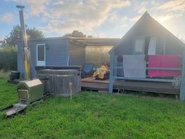 Shepards hut, kitchen, bathroom and joining sheltered area with sun loungers.