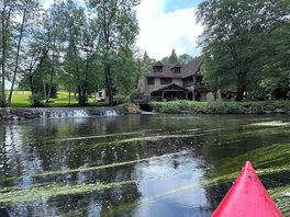 In the canoe next to the mill
