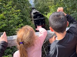 Seeing the steam train pass under the bridge on site.