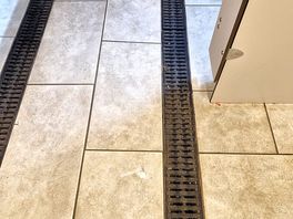 Floor between shower cubicles either site