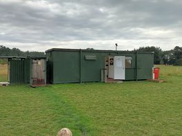Container mit küche und wc's. links befinden sich die outdoor-duschen.