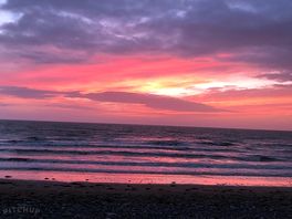 Sat and watched a stunning sunset on the beach, just a few steps from captain's house.