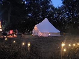 Bell tent lit up at night