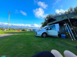 Our roof tent set up on camp site with gorgeous view