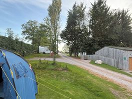 View from camping field towards caravans and facilities
