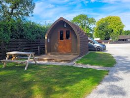 Pod with picnic bench and parking space.
