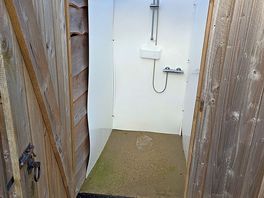 A shower, the door has hooks to hang your stuff. there is a also a family shower room