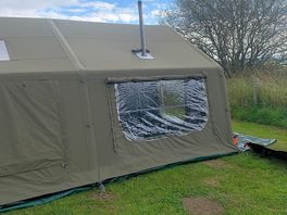 Side view of tent with window coverings rolled up.