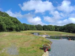 Entrance to site, and grass and gravel pitches