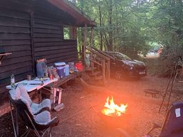 Good size fire pit and outside area facing the woods.