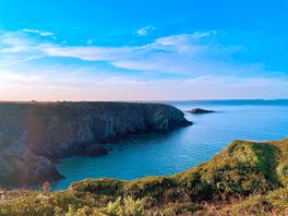 Sunrise over the campsite, from the coast path above caerfai beach