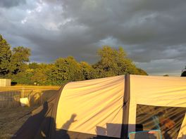 Sunlit tent with dark sky
