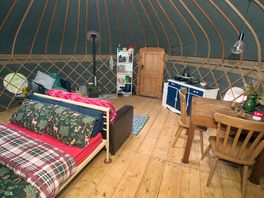 An open plan photo of inside the yurt