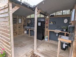 Kitchen / washup area with helpful local info in a folder, and device charging for a small donation