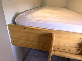Bunk beds at the rear of the pod, with storage, clothes rail opposite