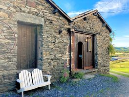 Entrance to Dog Crag Cabin with bench outside