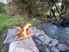 Raised campfire by the river near our pitch