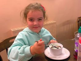 Happy granddaughter enjoying her dessert at the anvil inn
