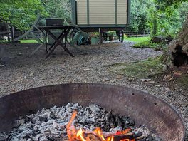 Infront of the firepit behind the yoman shepherd’s hut