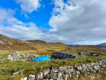 Tent pitch sheltered by stone walls