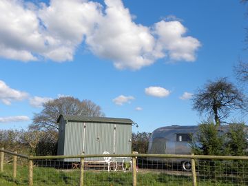 Airstream and shepherd's hut on a private farmland pitch
