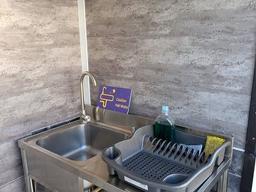 Dish washing station with free hot water