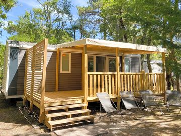 Caravan shaded by trees