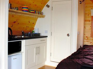 The kitchen with door to the wet room in the background