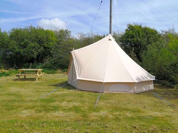 Each tent has a picnic bench outside