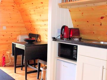 Kitchen showing the microwave and fridge