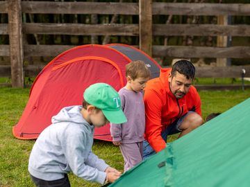 Family setting up a tent