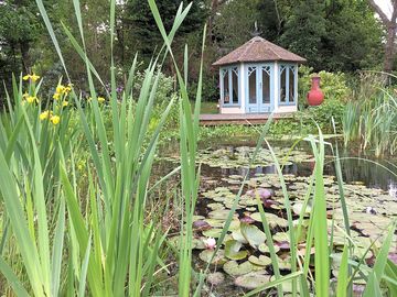 The octagonal thatched summer house is used solely by the gypsy van guests and great for relaxing.