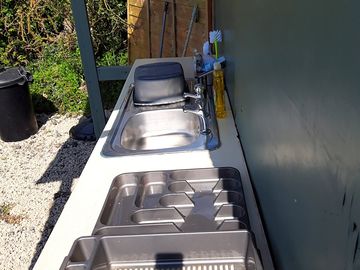 Washing up area equipt with cloths brillos washing up liquid etc