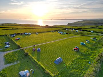 Camping field without electric, spacious pitches round the edge of a large field with sea views.