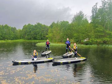 Paddleboarding activities on the pond
