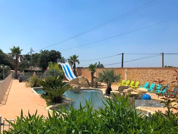 Pool with slides and sun loungers