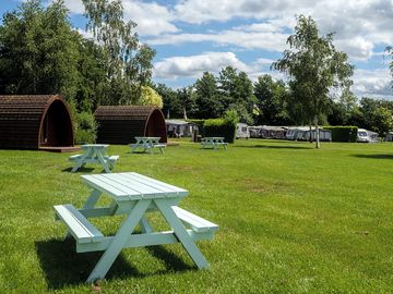 Picnic bench seating outside the pods