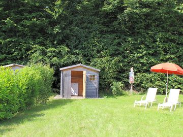 The premium pitch with a small shed, sun loungers and a fridge