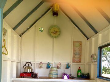 Inside your own private kitchen shed and storage area, to keep your tent clutter free.